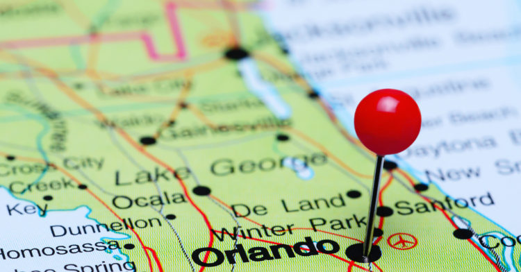 Photo of pinned Orlando on a map of USA. May be used as illustration for traveling theme.